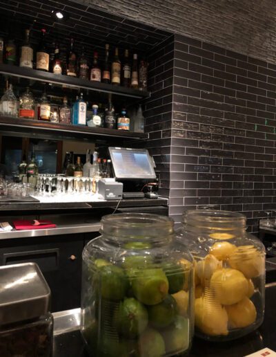 A bar with jars of lemons.