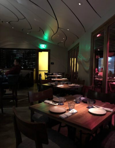 The interior of a restaurant with tables and chairs.