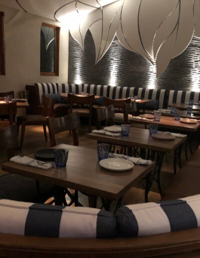 The inside of a restaurant with blue and white striped seating.