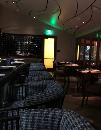 The interior of a restaurant with blue chairs.