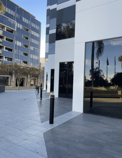 A sidewalk with a building in the background.