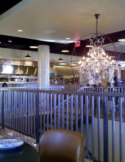 A restaurant with tables and chairs and a chandelier.