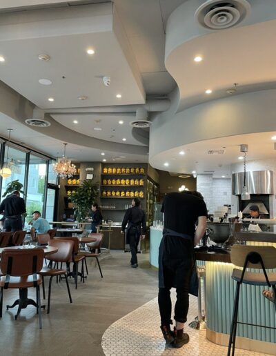 The interior of a restaurant with tables and chairs.