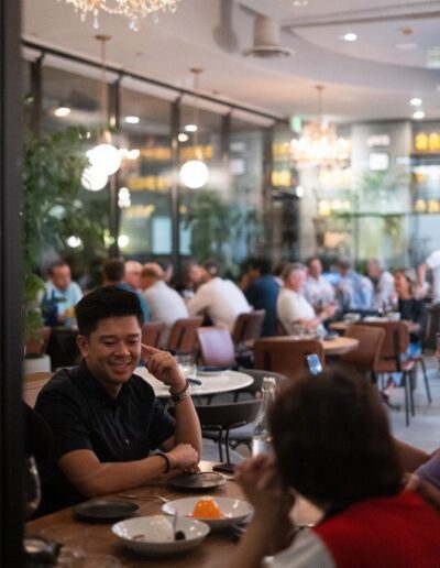 A group of people sitting at a table in a restaurant.