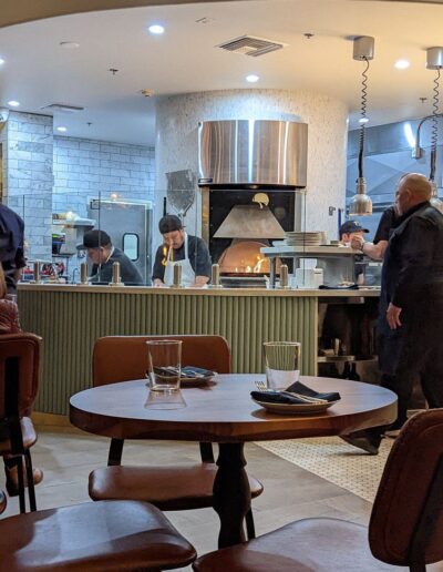 A group of people standing in a restaurant.