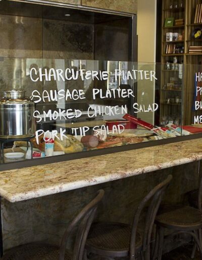 A chef standing behind a counter in a restaurant.