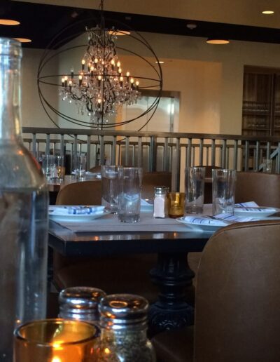 A restaurant with a table and chairs and a chandelier.