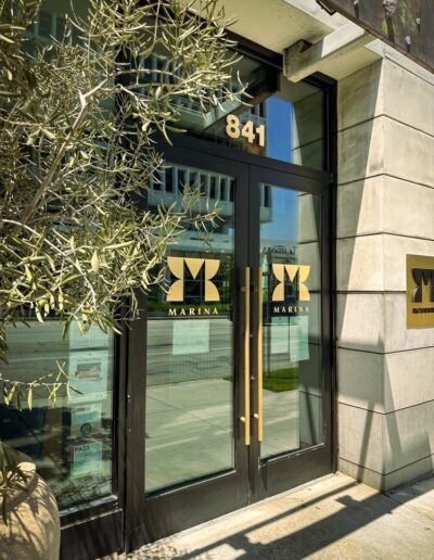 The entrance to a building with a plant in front of it.