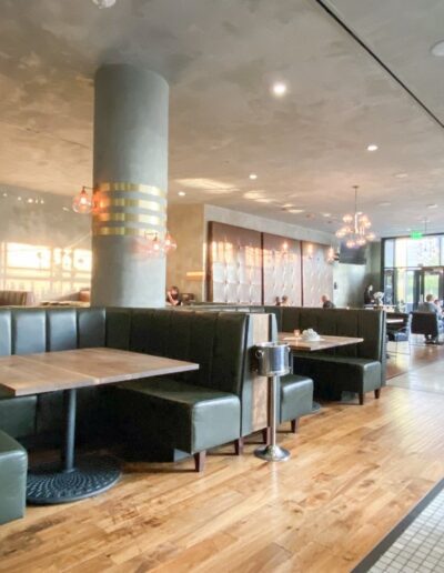 The interior of a restaurant with wooden tables and booths.