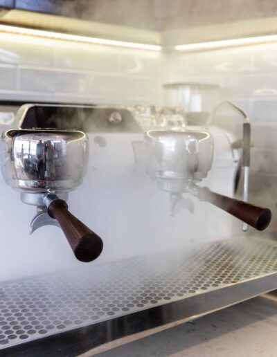 A coffee machine with steam coming out of it.