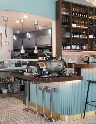 The interior of a restaurant with a bar and stools.