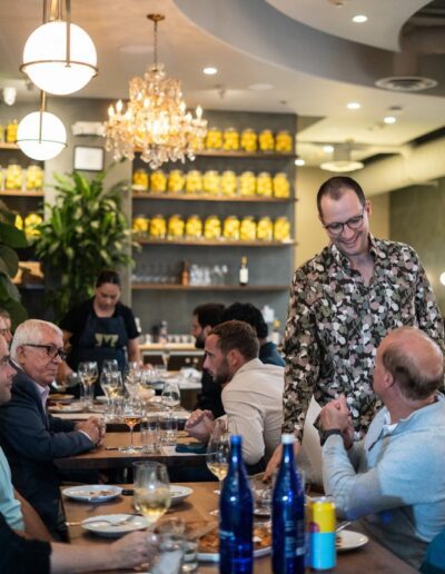 A group of people sitting at a table in a restaurant.