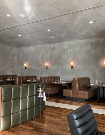 The interior of a restaurant with wooden tables and chairs.