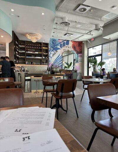 The interior of a restaurant with tables and chairs.