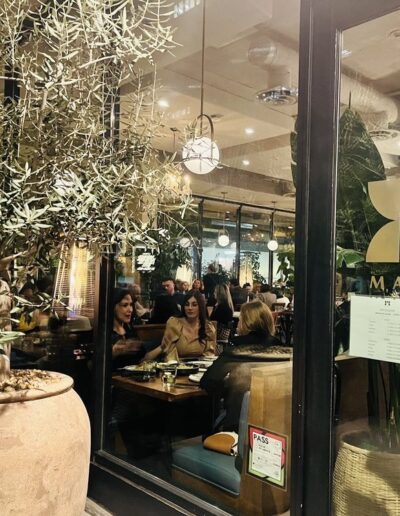 A group of people sitting at a table in a restaurant.