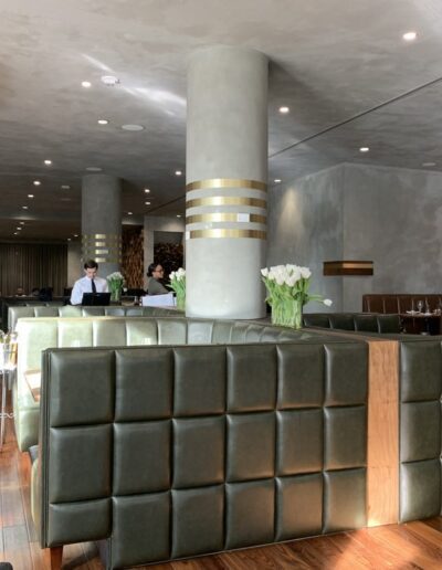 The interior of a restaurant with wooden tables and chairs.