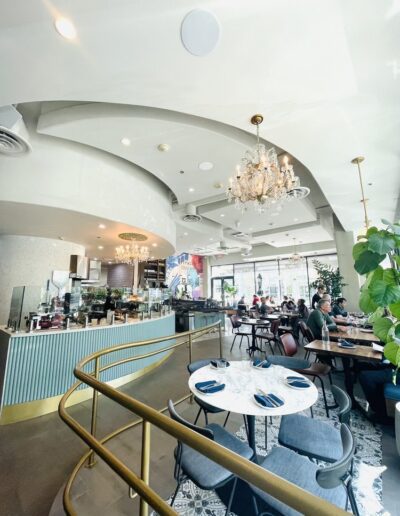 The inside of a restaurant with tables and chairs.